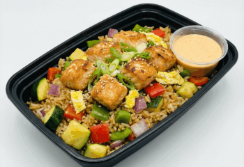 FRIED RICE: Salmon Bites w/ zucchini, green onion, egg, sesame seeds, side of sriracha sauce