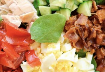 Cobb Chicken Salad w/ tomatoes, eggs,cucumber, cheddar cheese and mixed greens SIDE of BACON & RANCH