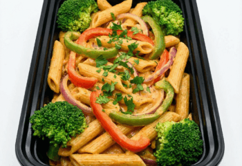 Cajun Penne Chickpea Pasta w/ peppers, broccoli, cajun vegan alfredo, parsley