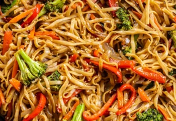 Vegan Veggie Stir Fry w/ linguine, broccoli, cherry tomatoes, cabbage, carrots, zucchini tossed in hibachi sauce, green onions, sesame seeds