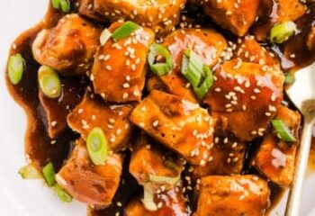 Teriyaki Salmon Bite Hibachi over noodles, shredded carrots, zucchini, side of sriracha mayo, sesame seeds, green onion