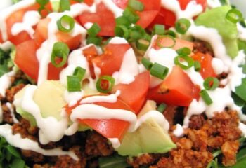 RAW VEGAN-Kale taco salad w/ tomatoes, cucumber, carrots, green onions, pecan mushroom crumble, jalapeno, cashew cilantro dressing