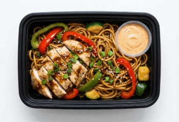 Chicken Hibachi w/ noodles, peppers, zucchini, side of sriracha sauce, sesame seeds, green onion